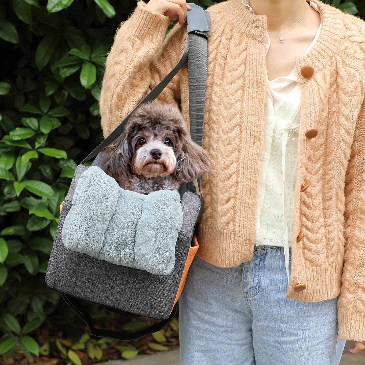 Small dog in gray cosy pet booster seat carry on
