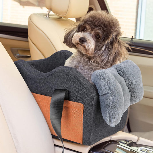 Small dog sitting in gray pet car booster seat on center console